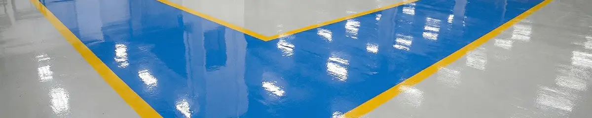 A factory floor professionally covered and marked with epoxy flooring in Arvada, CO