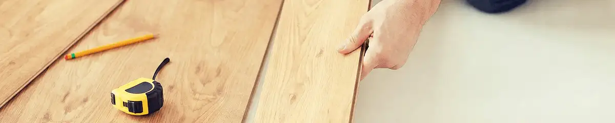 A professional installing wood flooring in Arvada, CO
