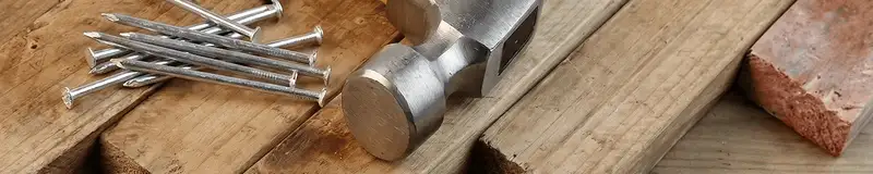 Hammer and nails on hardwood flooring boards in Arvada, CO
