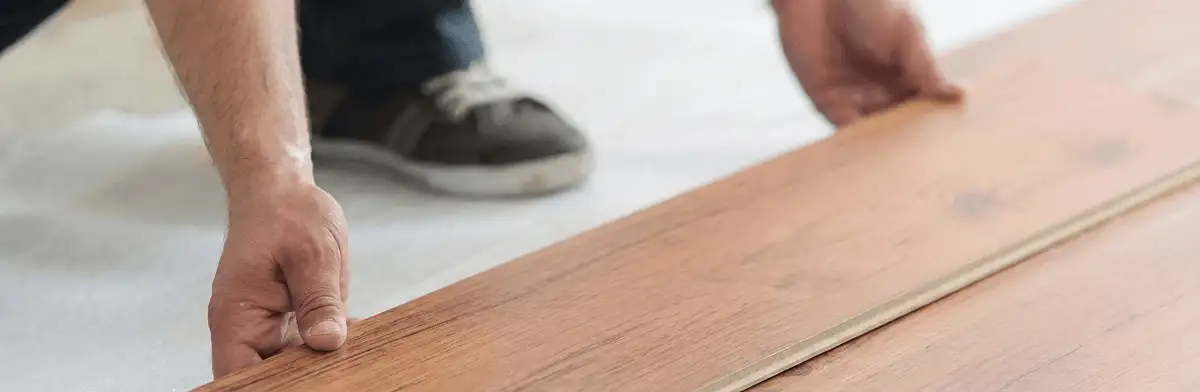 A professional installing laminate flooring in Arvada, CO
