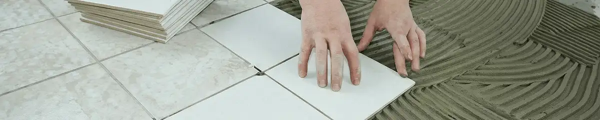 Professional installing white tile floors in Arvada, CO