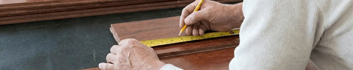 A professional installing wood flooring in Arvada, CO